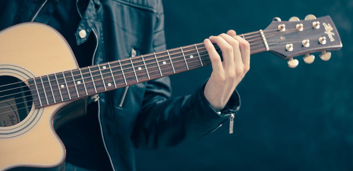 Photo of a person palying a guitar