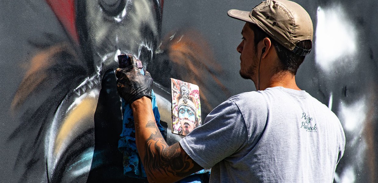 Photo of a person using spray paint to make an art piece