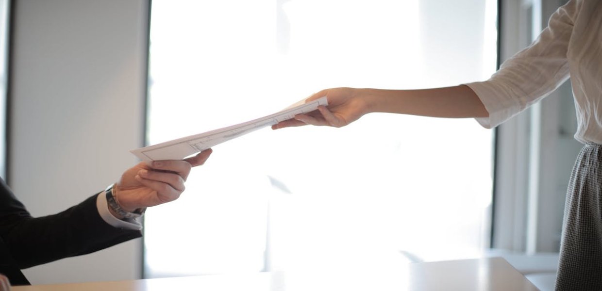 Photo of people passing paper between them