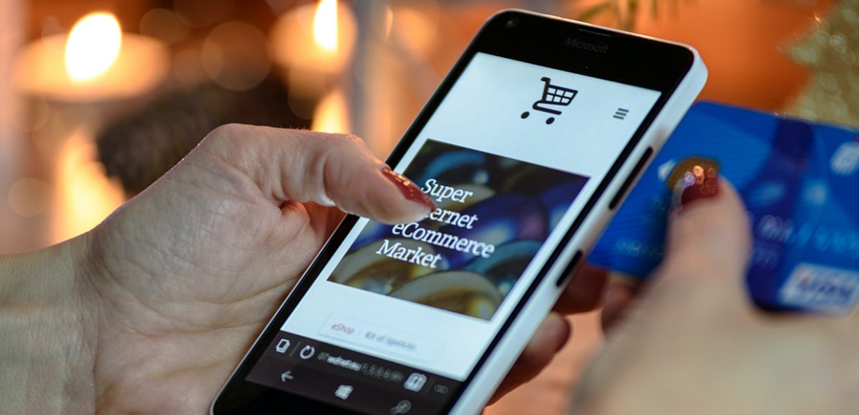 Photo of a person using a smartphone to grocery shop online