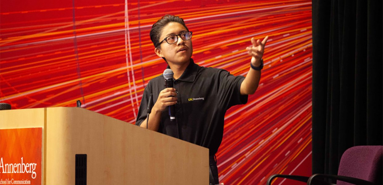 Man presenting at a podium at a previous USC Annenberg event