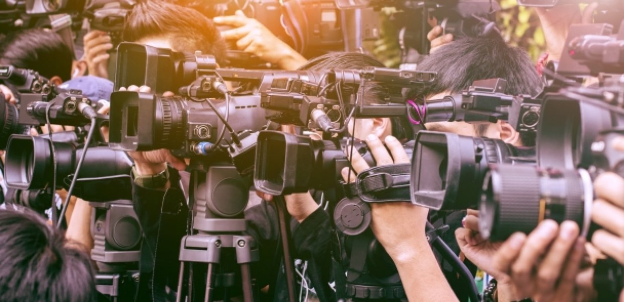 Photo of many news and media cameras pointed at the same target