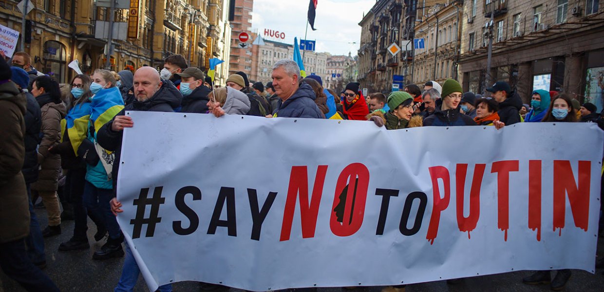 March of Ukrainian protesters against Russian aggression with political banner "Say No to Putin".