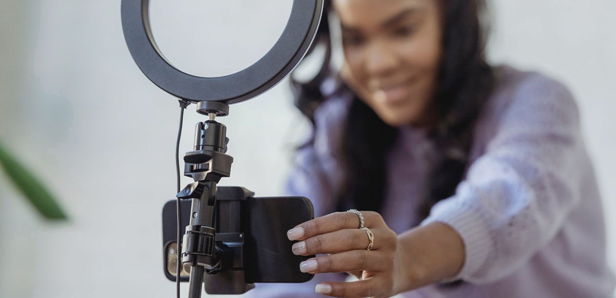 Photo of a person holding a phone ring light