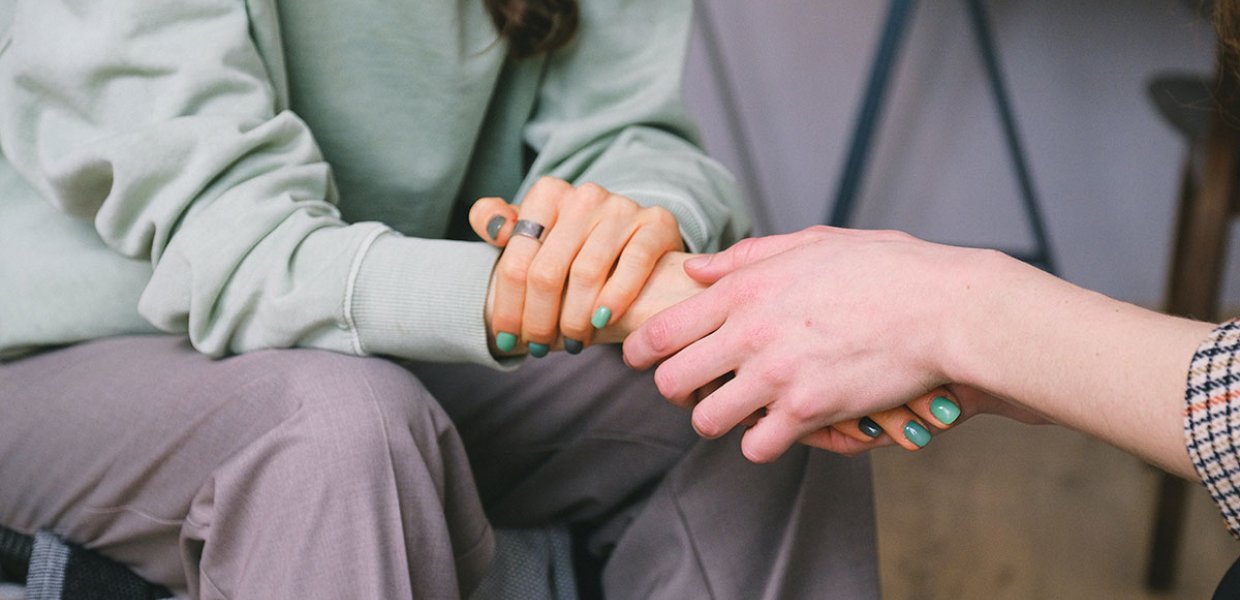 Photo of a person holding another person's hand