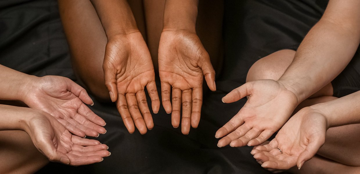 Photo of three sets of hands with palms facing upward