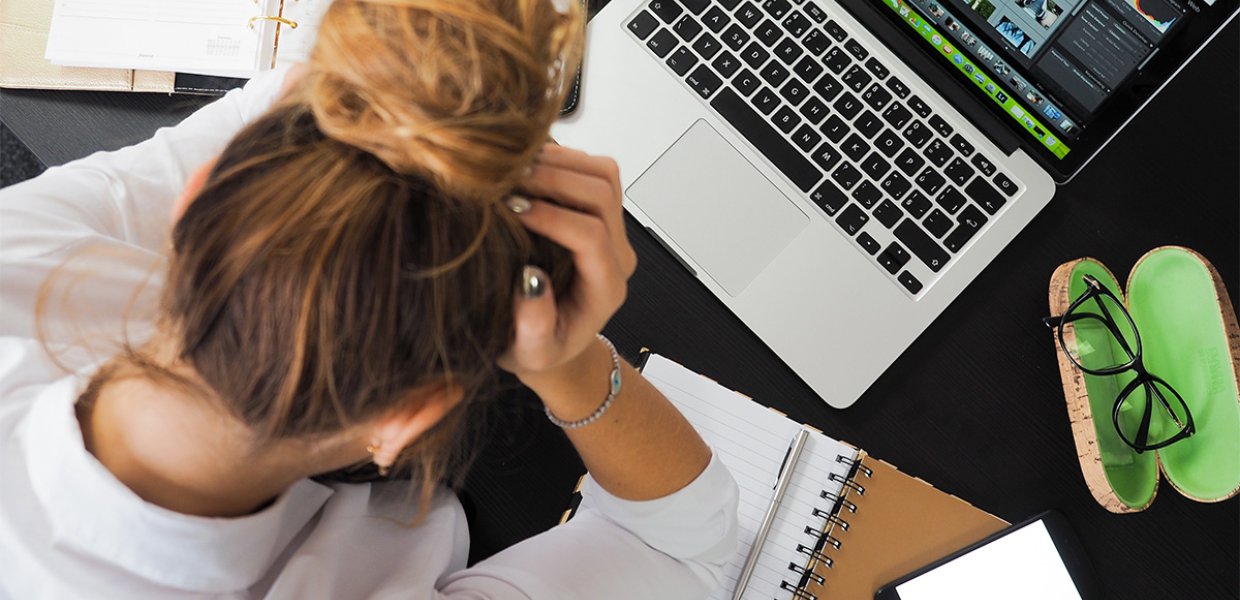 A student in distress looking at a laptop