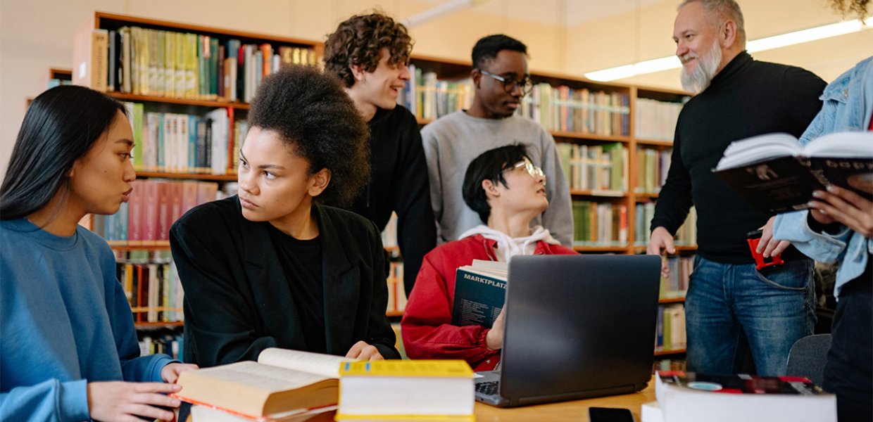 A group of seven people studying.