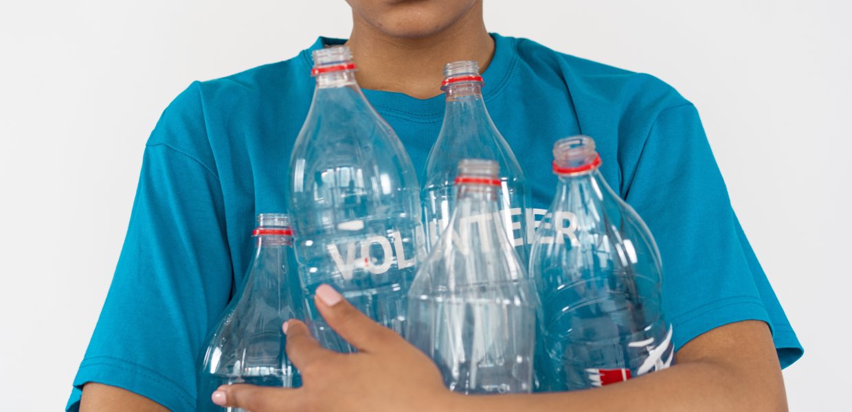 Image of a person holding empty plastic bottles