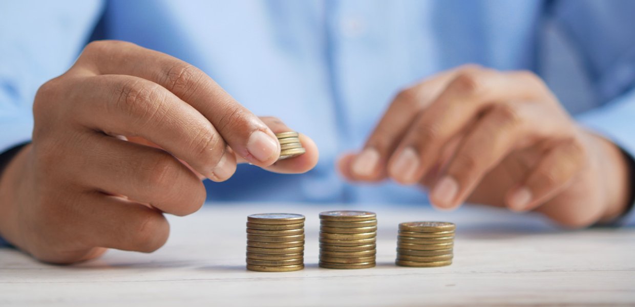 Hands stacking coins. 