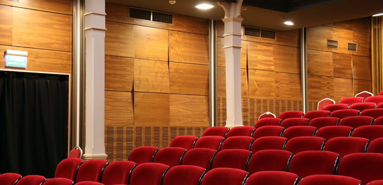 Photo of empty chairs in a movie theater