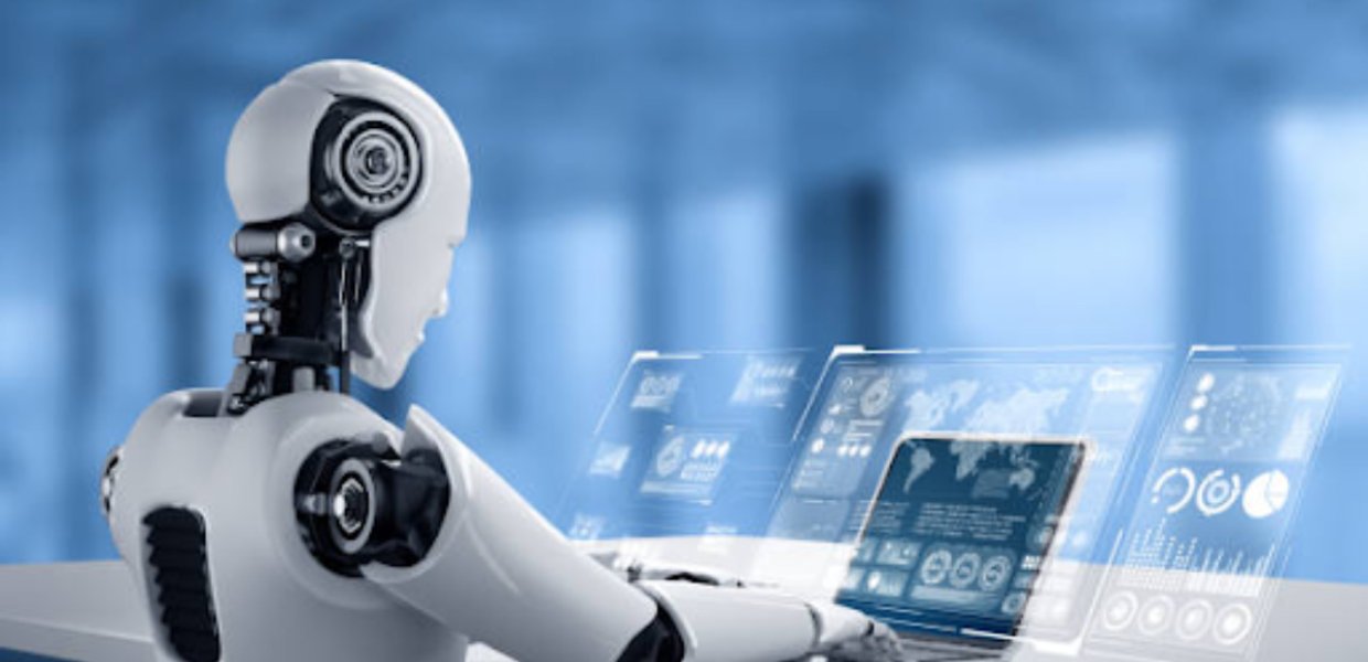 A robot typing on a laptop, sitting at a desk