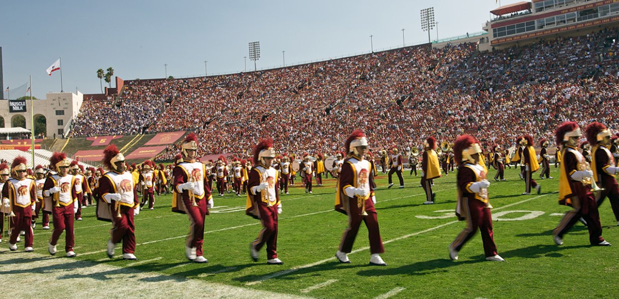 The USC marching band playing during a sporting event in the coliseum.