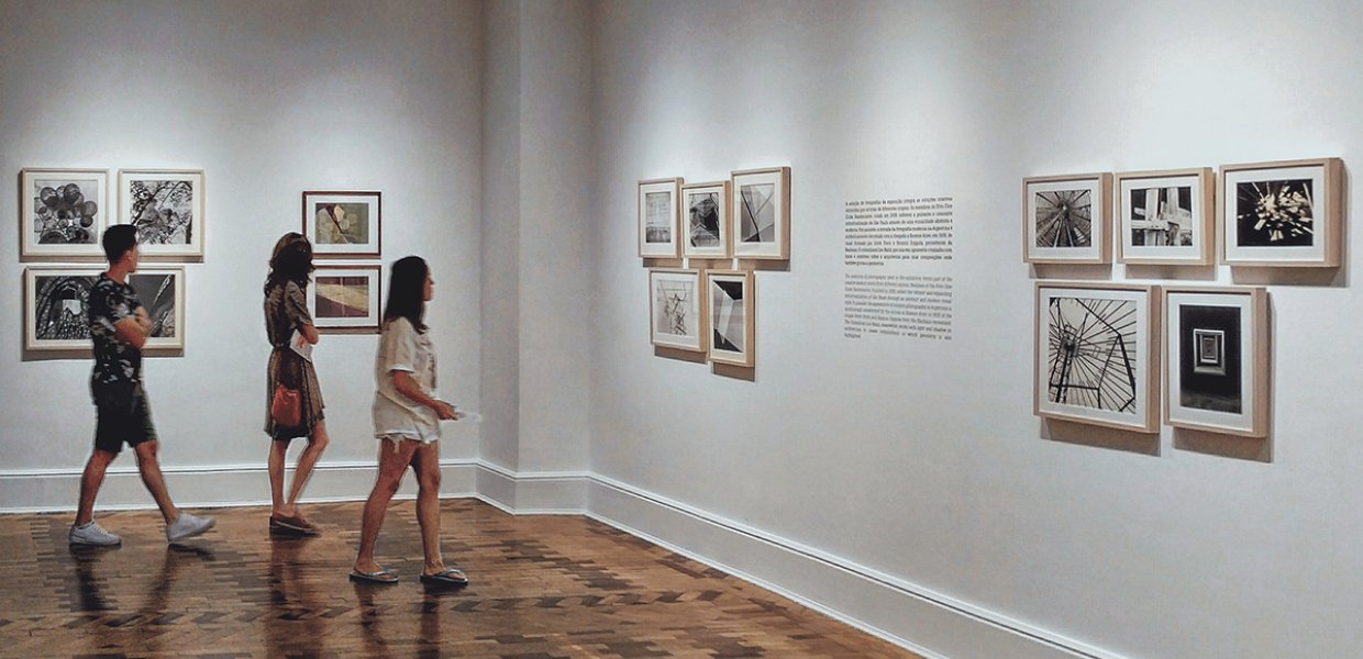 Photo of people walking around an art gallery