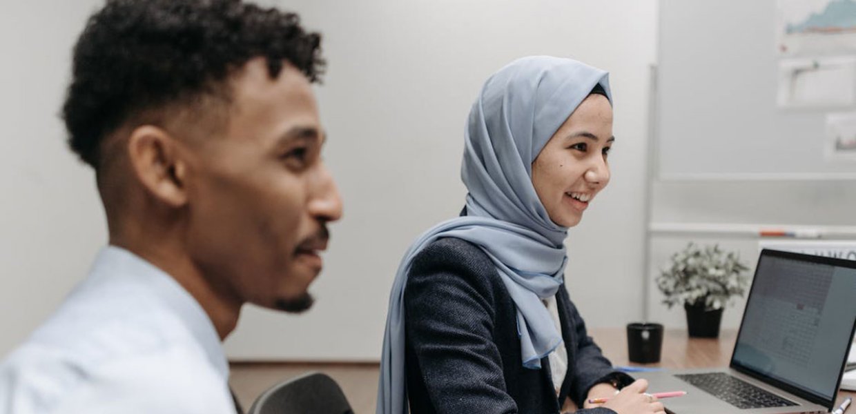 Photo of two people sitting in an office