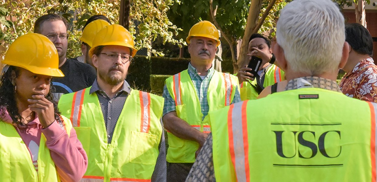 Group at USC wearing safety jackets and hard hats