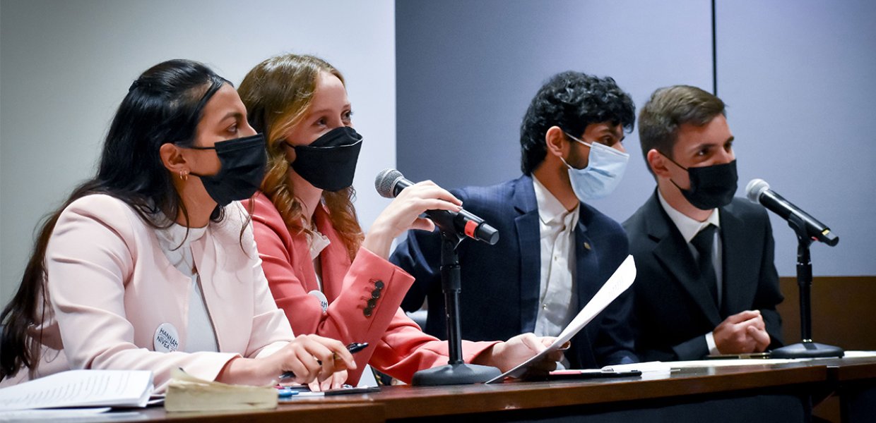 Four candidates at a panel.