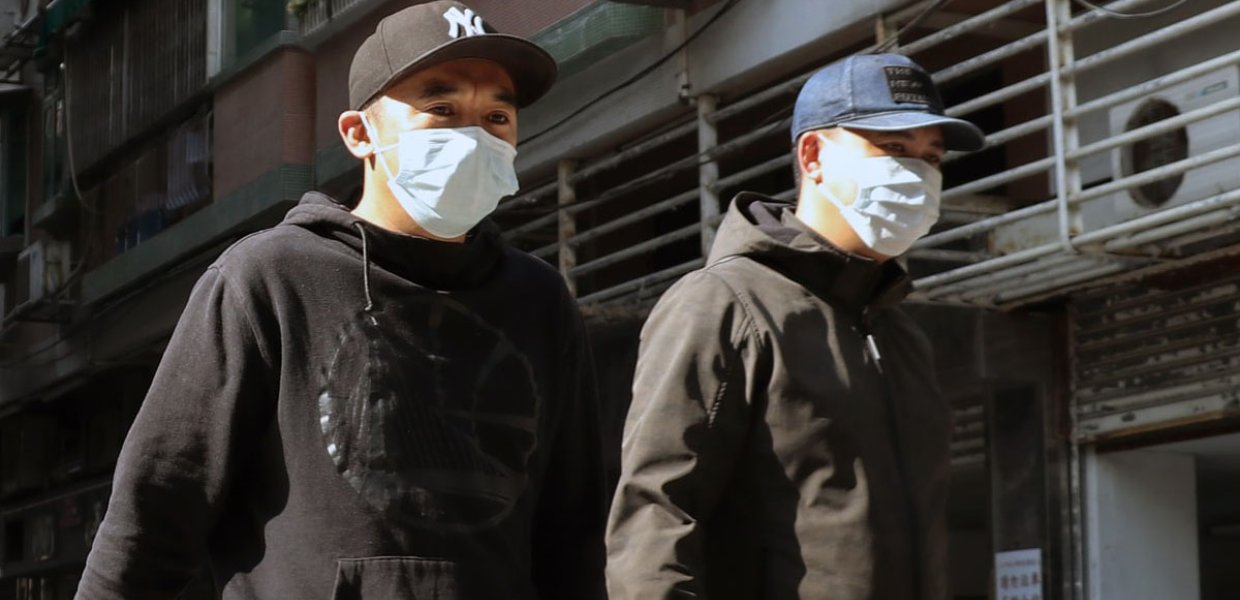 Photo of two people wearing masks