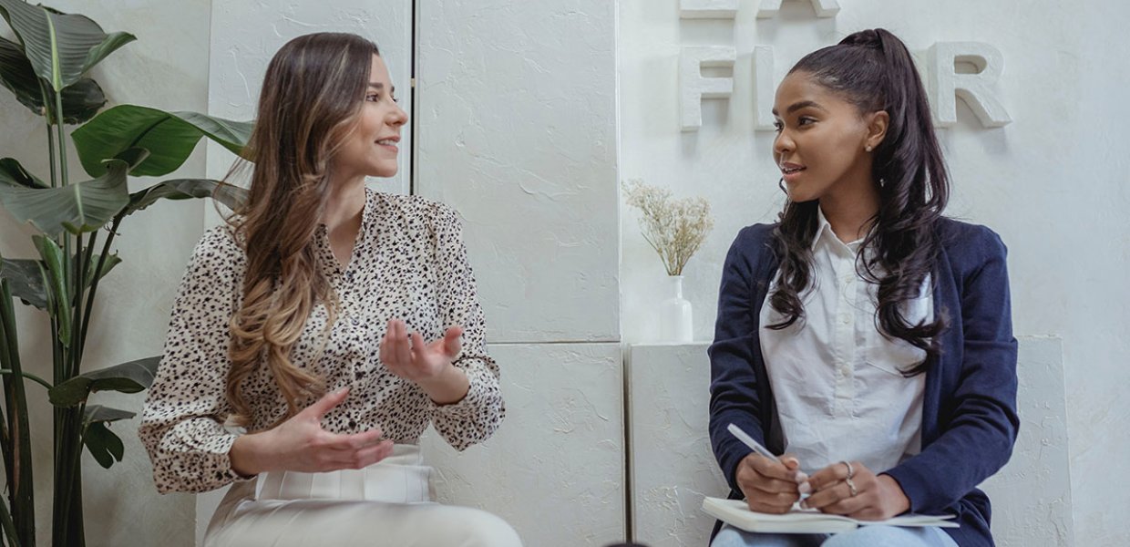 Photo of two women speaking to eachother