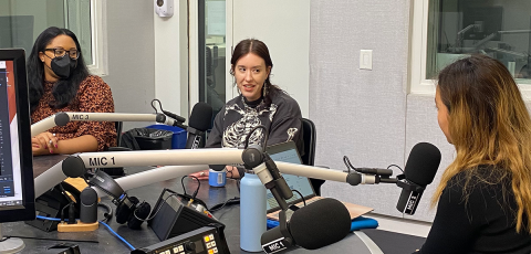Three women in discussion in podcast studio