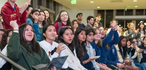 A crowd of students reacting to election results in the USC Annenberg Forum. 