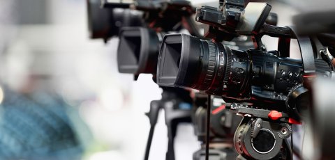 A camera on a tripod next to another of the same