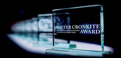 Glass awards extend back into a black background.