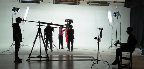 Filming an actress by a film crew on the set Backstage shot.