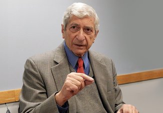 Photo of Marvin Kalb in a classroom setting dressed in a suit