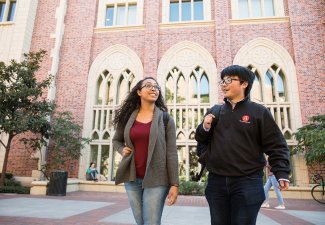 Photo of two USC Annenberg students walking outside of USC Annenberg