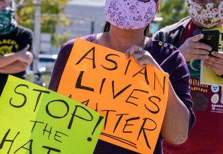 Image of Los Angeles rally where people hold signs that read "Stop the Hate!" and "Asian Lives Matter"