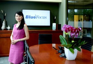 Photo of Holly Zheng in a conference room