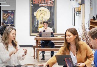 Photo of people collaborating and working on laptops.