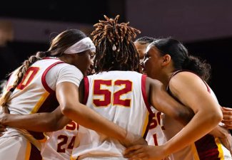 Women's basketball players for USC, hugging.