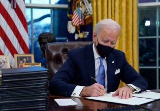 Photo of Biden signing an executive order