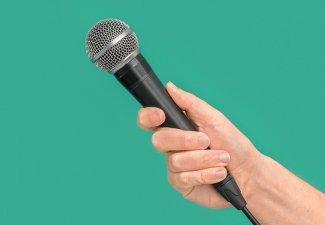 Photo of a hand holding a microphone
