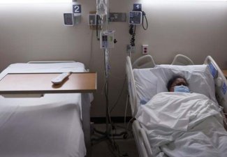 A person in a hospital bed. 