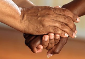 Photo of hands clasped together