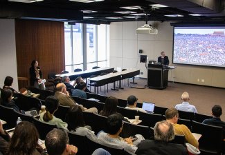 A man addressing a classroom full of people