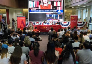 Students watch as Judy Muller, USC Annenberg professor; Antonia Hernandez, CA Community Foundation President/CEO; and Gordon Stables, USC Annenberg Assistant Dean of Student Affairs, discuss their predictions on how the first presidential debate will pan 