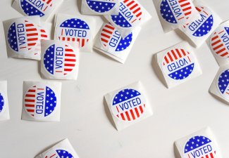 Photo of many I Voted stickers on a table