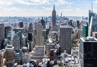 Photo of the Empire State Building in New York City, NY amongst many other buildings