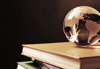 Illustration of a globe balanced on a stack of books