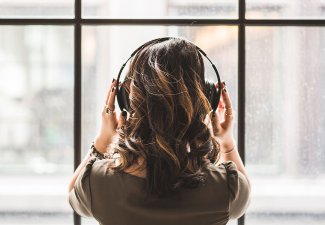 Photo of a person listening to music with headphones