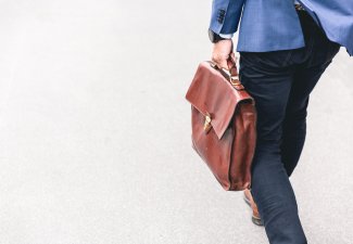 Photo of a person carrying a leather briefcase