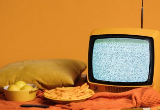 Photo of some snacks next to a television