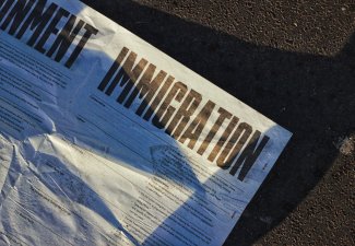 Photo of a paper that reads "Immigration" in big, bolded font
