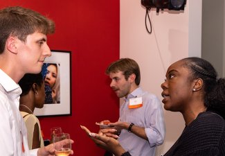 Four people engaged in discussion at a previous Annenberg networking event