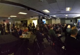 A classroom full of people facing a presentation