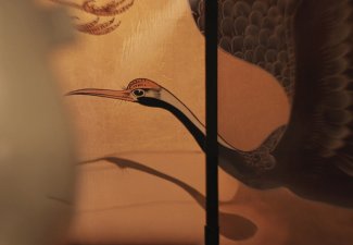 A crane against a yellow background